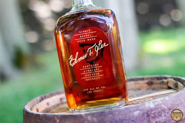 Elmer T Lee Single Barrel bottle displayed on a wooden table, highlighting its rich amber color and detailed label.